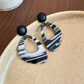 Close-up of retro black and white marbled striped teardrop hoop earrings on a plate. - Black and White Teardrop (6#)