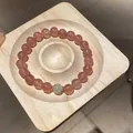 Natural strawberry quartz beaded bracelet with a green stone accent on a wooden display - Style 80 (Single Loop Beaded) / Pink