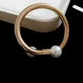 Elegant gold snake-pattern bracelet with two white pearls on black background. - Snake Bone Double Pearl Cuff (22#)