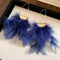 Detailed macro view of elegant blue feather tassel earrings with pleated gold finish. - Hook Style (HE29174) / Alloy Ear Hook / Blue
