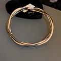 Detailed view of the layered metal snake chain texture on this twisted choker necklace - Wrapped Necklace / Gold-Silver