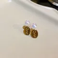 Detailed macro view of vintage gold oval flower earrings featuring iridescent pearl beads - Sunflower (6#)
