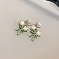 Close-up of elegant pearl flower earrings with green leaf details and silver pins. - Lily Of The Valley (13#)