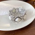 Detail of retro silver bracelet with white rhombus acrylic inserts on white plate - Silver-White