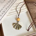 Retro ginkgo leaf pendant necklace featuring a natural wood bead on a brown cord - Ginkgo Leaf Wood Bead Style (6#)
