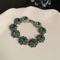 Elegant vintage bracelet featuring emerald green crystals and floral metal settings - 40# Bracelet