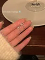 Elegant sparkling silver snowflake stud earrings held in hand for cozy winter style - Silver Earring Post Style / Silver