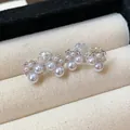 Detail shot of elegant French bow clip-on earrings featuring white pearls and zircons - Mosquito Coil Clip-on Earrings (HE29904) / Silver