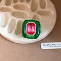 Close-up of vintage resin ring with pink center stone and green pleated frame - Green and Rose Red