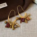 Detailed view of vintage ethnic gold-plated earrings featuring multi-color stone tassels. - Ear Hook Tassel Style / Brown