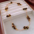 Elegant layered tiger eye beaded necklace with gold spacers displayed in a white jewelry box - Necklace (40#) / Gold Brown