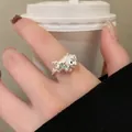 Detailed macro view of a cute silver horse open ring with a blue flower on finger. - Silver Cartoon Pony Blue Flower Style (12#)