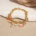 Ocean theme gold-plated charm bracelet featuring seashell, dolphin and star pendants. - Dolphin Charm Bracelet (HB2985) / Gold Pink