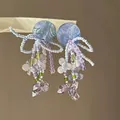 Close-up detail of handmade beaded flower tassel earrings with blue iridescent discs - Blue-Purple Disc Tassel Style (45#)