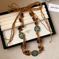 Boho handgeweven tailleketting met houten kralen, hennep touw en blauwe bloemen - Koffie Ingelegde Maan (HN8722) / Bruin
