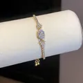 Elegante bracciale in zirconia ovale color oro per donna con delicati motivi a farfalla - Oro-Trasparente