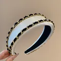 Elegant white satin padded headband with gold chain and black velvet ribbon detail - Off White