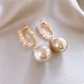 Vista detallada de pendientes de aro dorados con circonitas y perlas color champán - Pendientes Perla Champán Circonia