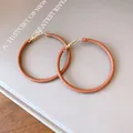 Detailed view of fashionable brown leather-wrapped round hoop earrings for women - Dark Coffee