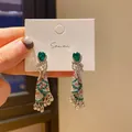 Close-up of ethnic style silver earrings with green teardrop stones and tassel detail. - Bohemian Ethnic Style (HE27136) / 29# Silver Post - Silver Green Pink