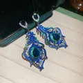 Close-up detail of vintage style peacock feather drop earrings with blue and green zircons - Luxurious Teardrop Feather / Silver Needle / 10# Silver Blue