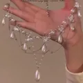 Detailed macro view of an elegant silver necklace with pearls and butterfly pendants - White Pearl Butterfly Tassel Chain (8#) / Silver/White