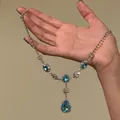Detailed view of an elegant blue crystal pendant necklace with rhinestone accents - Sky Blue Oval Drop Rhinestone Chain (11#) / Silver/Blue