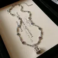 Close-up detail of retro silver necklace with a square floral pendant and colorful stones - Necklace (WN420) / Silver
