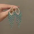 Detailed macro shot of elegant gold chandelier earrings with blue gems and micro crystals. - Style 4# Gold Blue (Silver Pin)