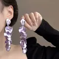 Detailed view of elegant long cascading purple metallic petal drop earrings worn by a model - 12# Steel Needle - Purple