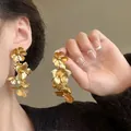 Detailed close-up view of gold cascading floral earrings worn by an elegant model - 28# Silver Needle - Matte Gold