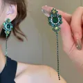 Detail shot of green emerald-style crystal flower earrings with long tassels. - 36# Silver Pin - Green