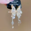 Macro detail of exquisite sparkly butterfly earrings featuring zircons and dangling crystals - 38# Silver Needle - Gold