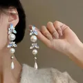 Detailed view of elegant drop earrings featuring iridescent crystals and pearls. - 42# Silver Earring Post-Silver-White