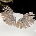 Close-up of luxury sparkling fan-shaped wing earrings encrusted with white zirconia stones - 46# Steel Needle - Gold White