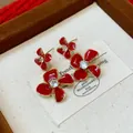 Close-up macro detail of red enamel flower earrings with central zircon in a jewelry box. - Double Layer Zirconia Style (2#) / Gold Red