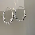 Elegant silver hoop earrings with crushed metal texture for a minimalist and modern fashion look - Style 23 / Silver