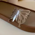 Close-up of a silver butterfly open cuff bracelet with hammered metal texture - Silver Hammered Butterfly Hollow Style (HB2501)