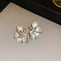 Macro view of elegant silver flower stud earrings with vibrant blue crystal accents - 6# Textured Floral Style / Silver