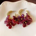 Close-up of vintage French style acrylic burgundy flower hoop earrings with gold accents - Silver Post-Tie-Dye Flower / Gold-Purple