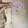 Close-up of purple fabric flower hair clip with delicate mesh petals and long tassels - Purple Flower Tassel - Duckbill Clip
