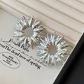 Elegant silver abstract sunburst stud earrings displayed on a beige jewelry tray - Abstract Starburst Style (107#) / Silver