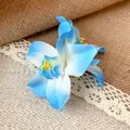 Close-up view of a blue and white fabric orchid hair clip with delicate petal textures - Blue Duckbill Clip