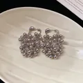Elegant silver metallic bead cluster fringe earrings displayed on a cream shell tray - Bead Grape Cluster Tassel Style (111#) / Silver