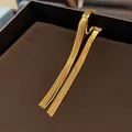 Detailed view of gold tassel ear cuff with elegant minimalist metal chain design - Single Piece / Gold