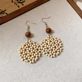 Hand-woven natural beige beaded flower drop earrings with a dark wood bead accent. - 66# Hand-Woven Wood Bead Flower Cluster Earrings / White