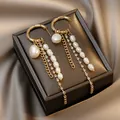 Detail of elegant gold C-shape tassel earrings featuring pearls, chains and rhinestones - C-Shaped Chain Tassel Style / Gold