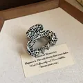 Elegant spotted oval mini hair claw clip with a stylish black and white pattern - 13 Hair Claw - Black and White Leopard