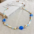 Detailed close-up of ethnic woven waist chain with blue stones and beads on linen - 35# Waist Chain - Blue