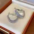 Close-up detail of geometric silver earrings with zircon inlay in a premium jewelry box - Geometric Hoop (Silver/White Zirconia)